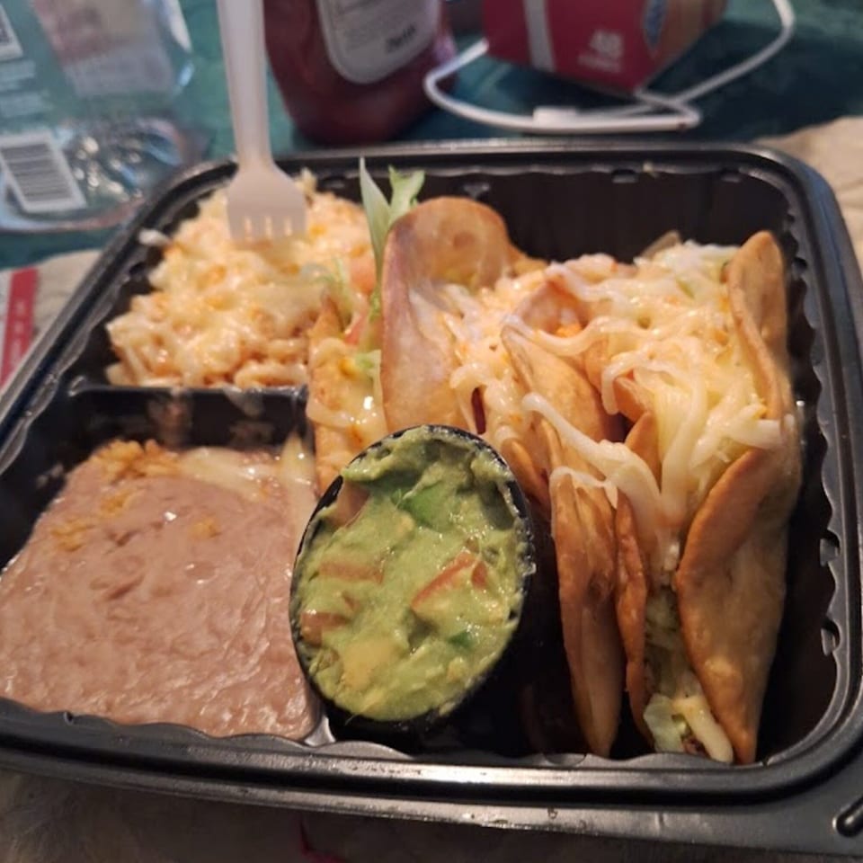 Dos Pesos Mexican Restaurant's take-out container with tacos, refried beans, guacamole, and mac and cheese.