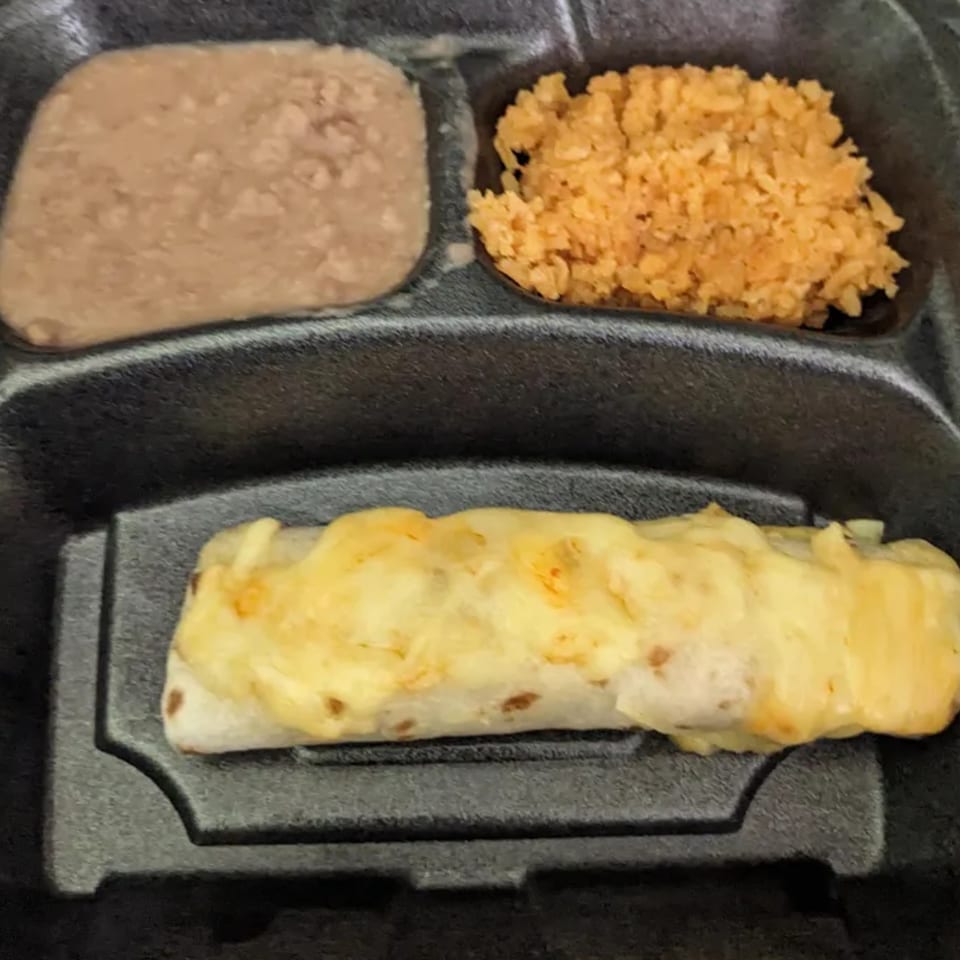 A Dos Pesos Mexican Restaurant takeout meal with a cheesy burrito, refried beans, and rice.